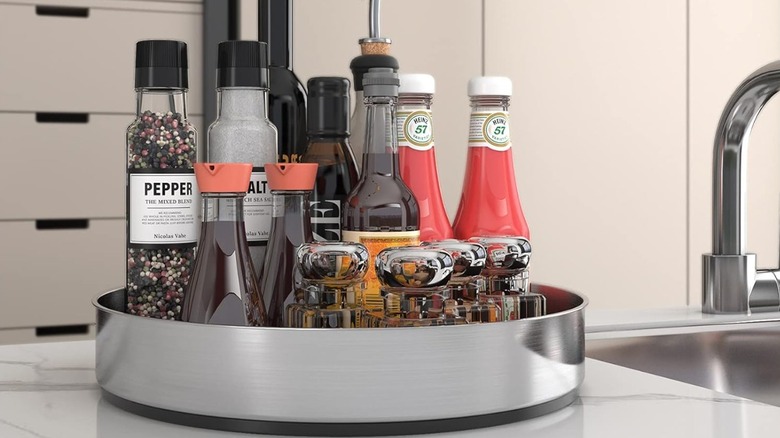 Condiments are stored on a stainless steel lazy Susan