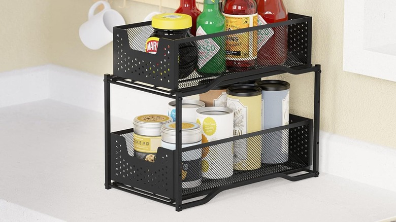 A black stackable organizer holds spices and condiments