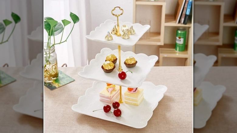 Pastries are displayed on a white tiered cupcake stand