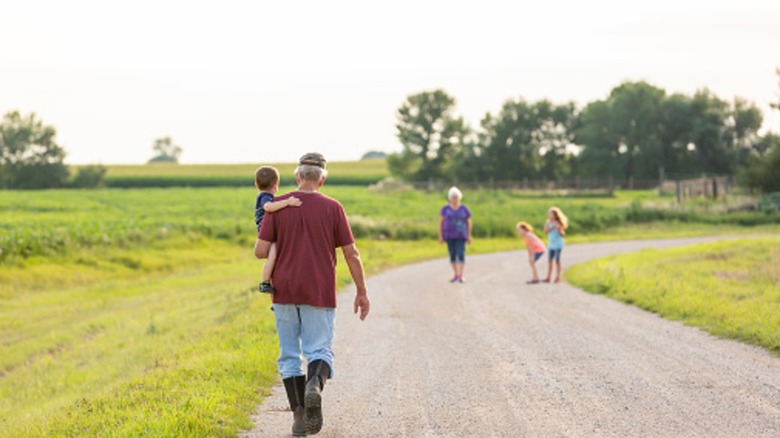 Family walking down a gravel driveway