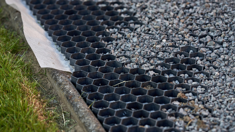 Black paver amidst gravel