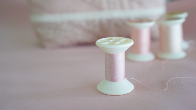 pink plastic thread spool