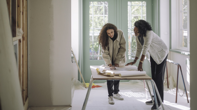 Two woman working on redecorating a home