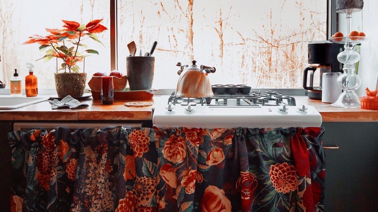 Kitchen with curtained cabinets