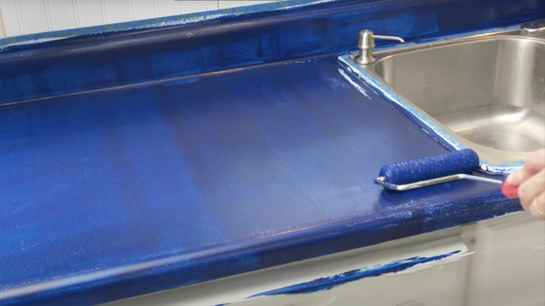 rolling blue paint over laminate countertop