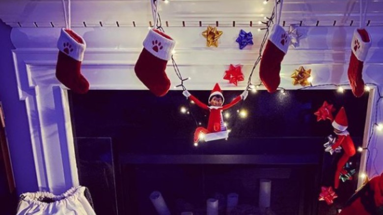 Elves and stockings on mantel