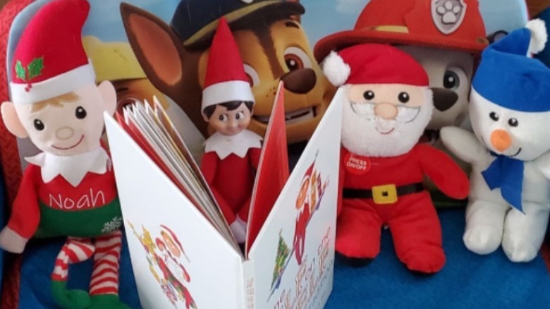 Elf with toys reading book