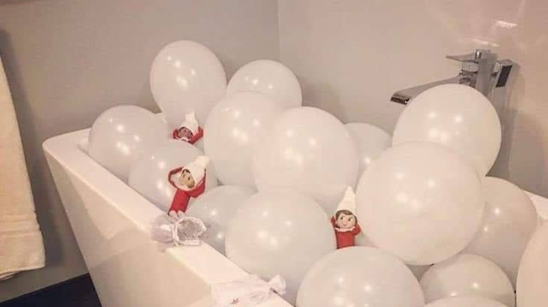 elves in bath of balloons