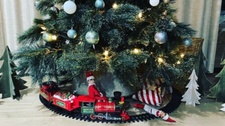 Elf on train under tree