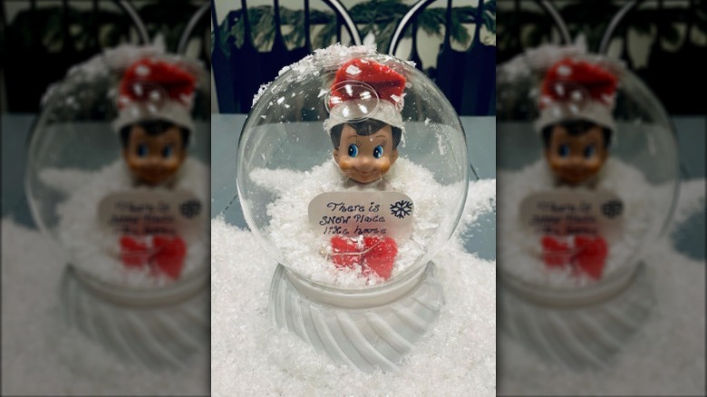 Elf in snow globe