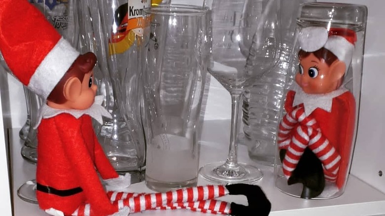 Elf trapped under drinking glass