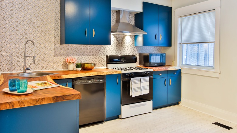 blue cabinets with wood counters