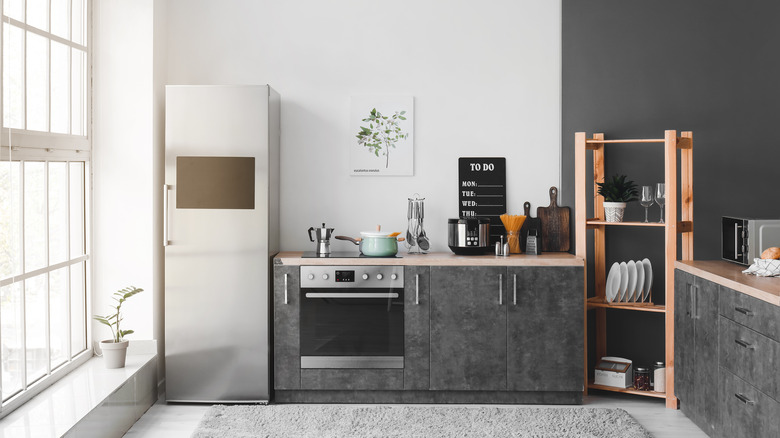 gray kitchen with wood shelf