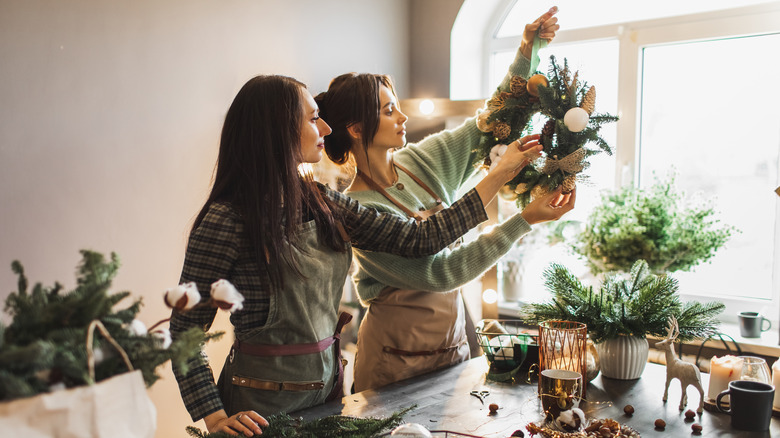 Women redecorating a wreath