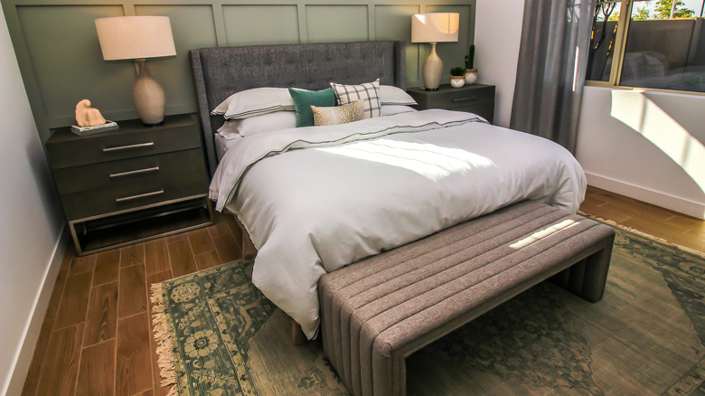 Master bedroom with a seating bench at the foot of the bed