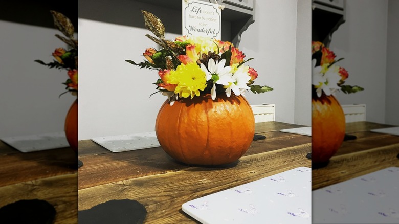 pumpkin centerpiece on wooden island