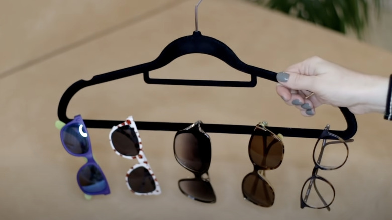 sunglasses hanging on clothes hanger