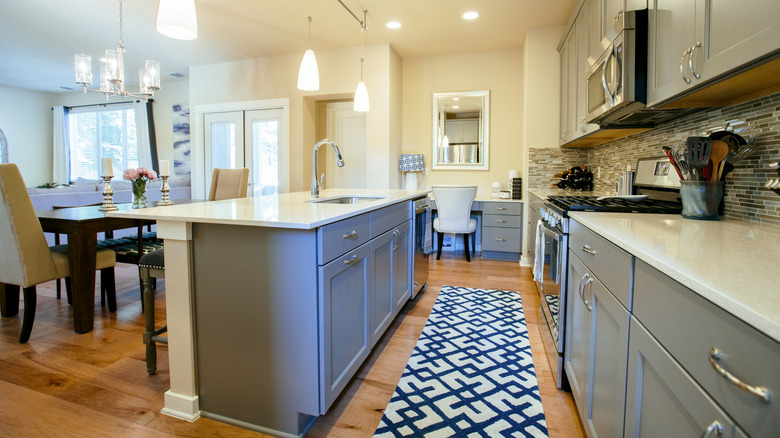 A kitchen with a blue rug