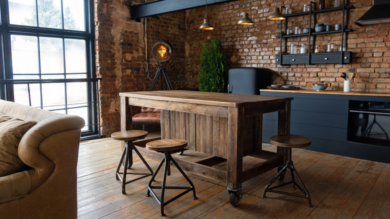 Kitchen with dark wood flooring and matte black cabinets