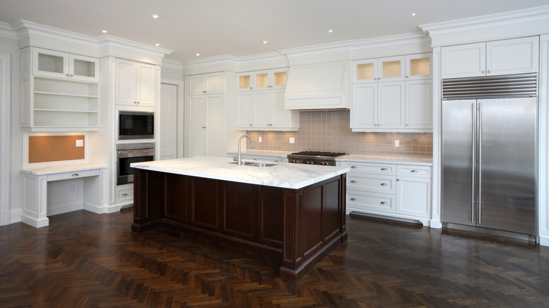 White cabinets and dark wooden island kitchen design