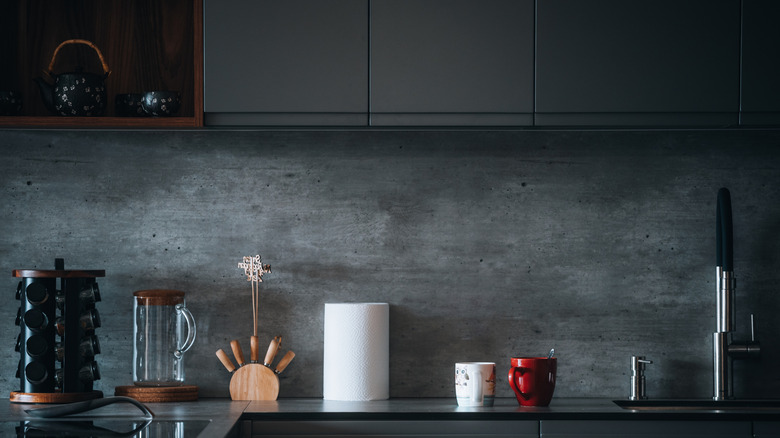 Dark gray cabinets with cement countertop kitchen