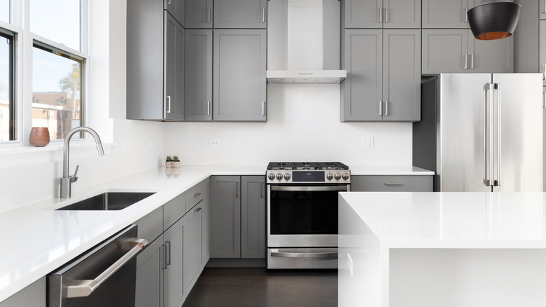 Gray and white kitchen on dark floors