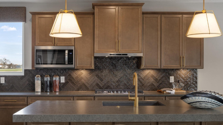 Brown kitchen cabinets with brass finishes