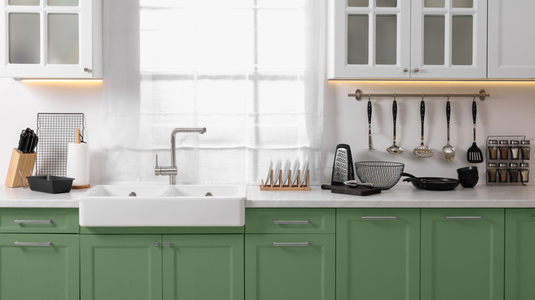 Sage green kitchen cabinets with quartz counters