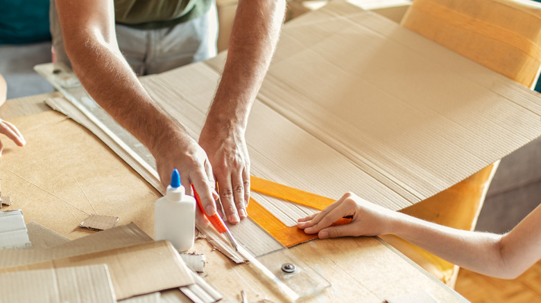 Person cutting cardboard