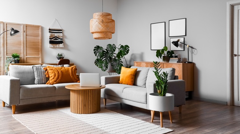 Gray living room and sofas which yellow scatter cushions