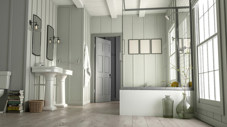 En suite luxury bathroom with pedestal sinks 