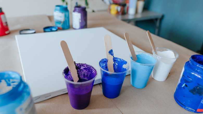 paint in disposable plastic cups