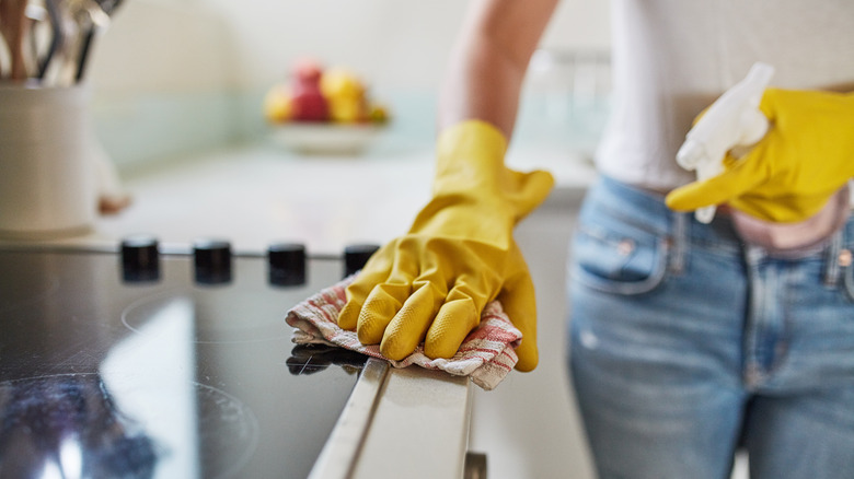 woman wiping counter with rag