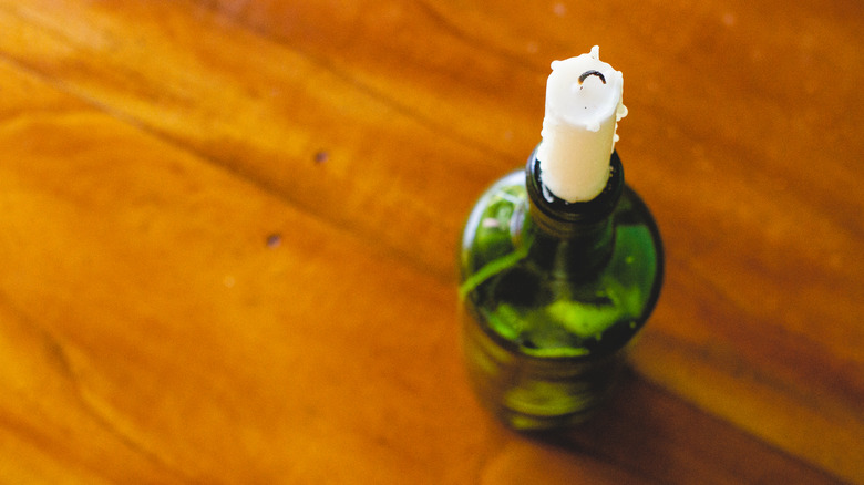 candle in green wine bottle