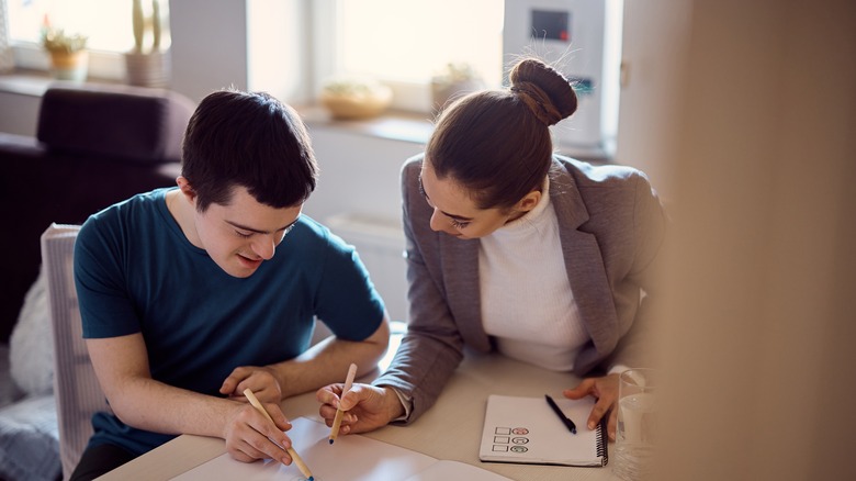 couple planning and writing in notebook