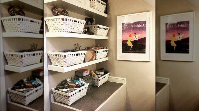 white floating shelves with baskets