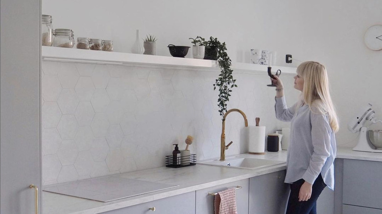 woman looking at kitchen shelf