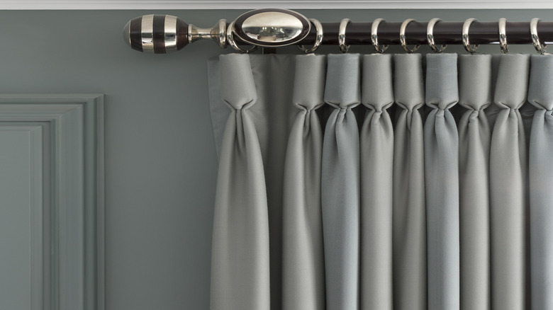 New metal curtain rod and hooks with a gray curtain