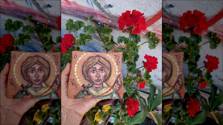 terracotta piece painted with saint