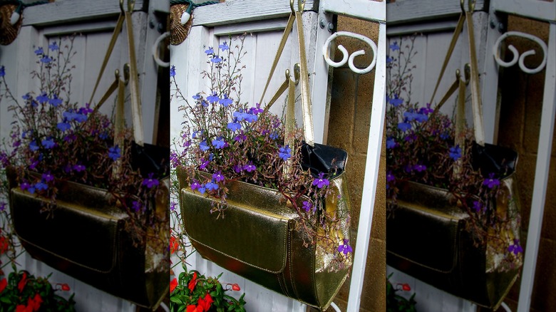 Large purse holding flowers hanging outside