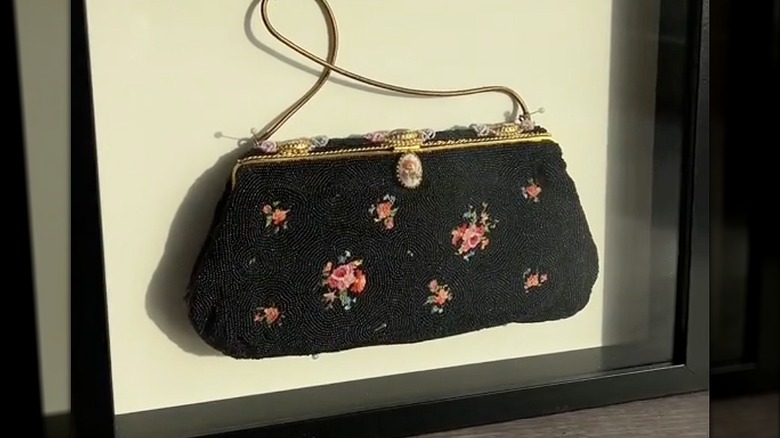 Beaded clutch handbag inside a shadow box