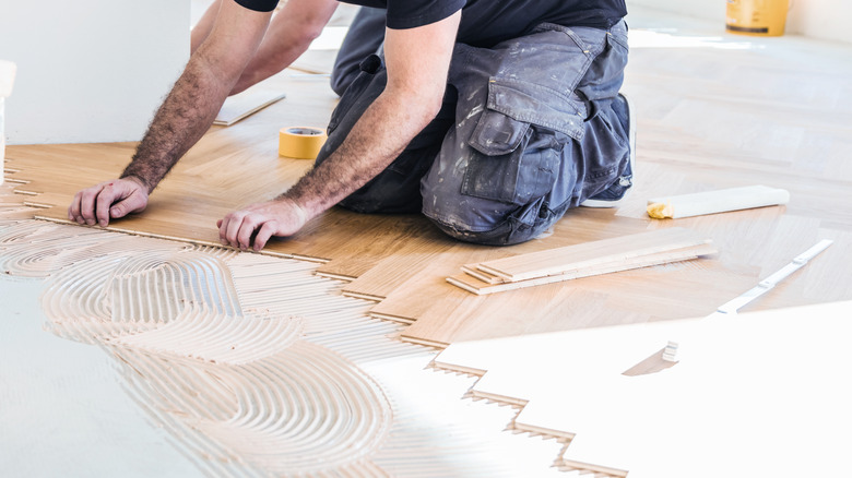 Carpenter laying out wood planks