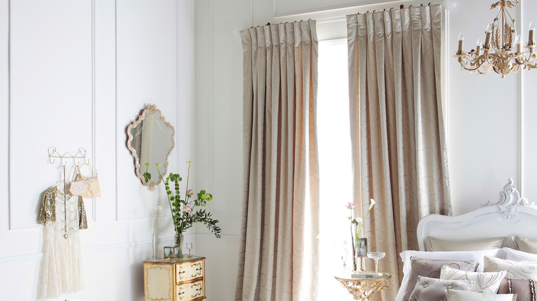 White living room with oyster satin drapes.