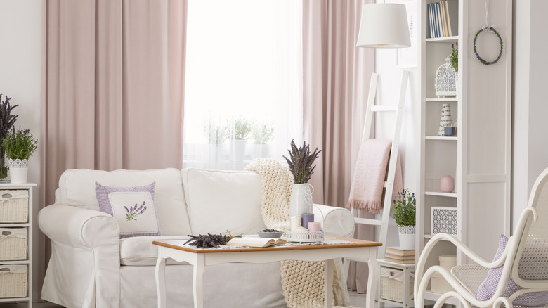 White room with pale pink curtains.