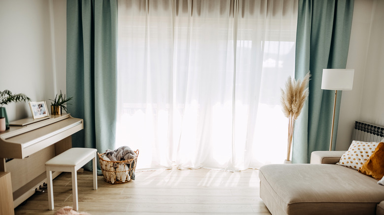 White living room with pale blue drapes.