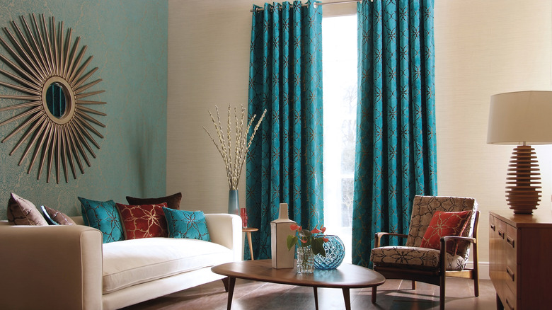 White living room with turquoise curtains.