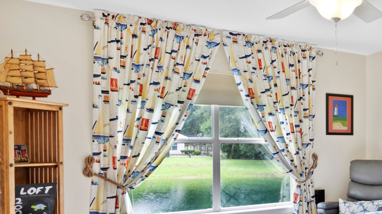 Curtain fabric with a nautical theme containing sailboats on window