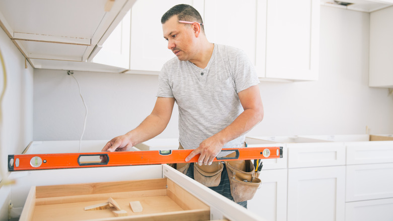 person installing custom cabinets