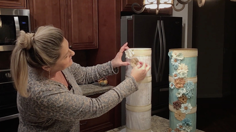 woman making floral toilet paper holder