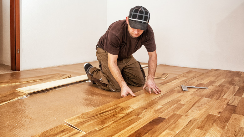 man installing engineered hardwood floors